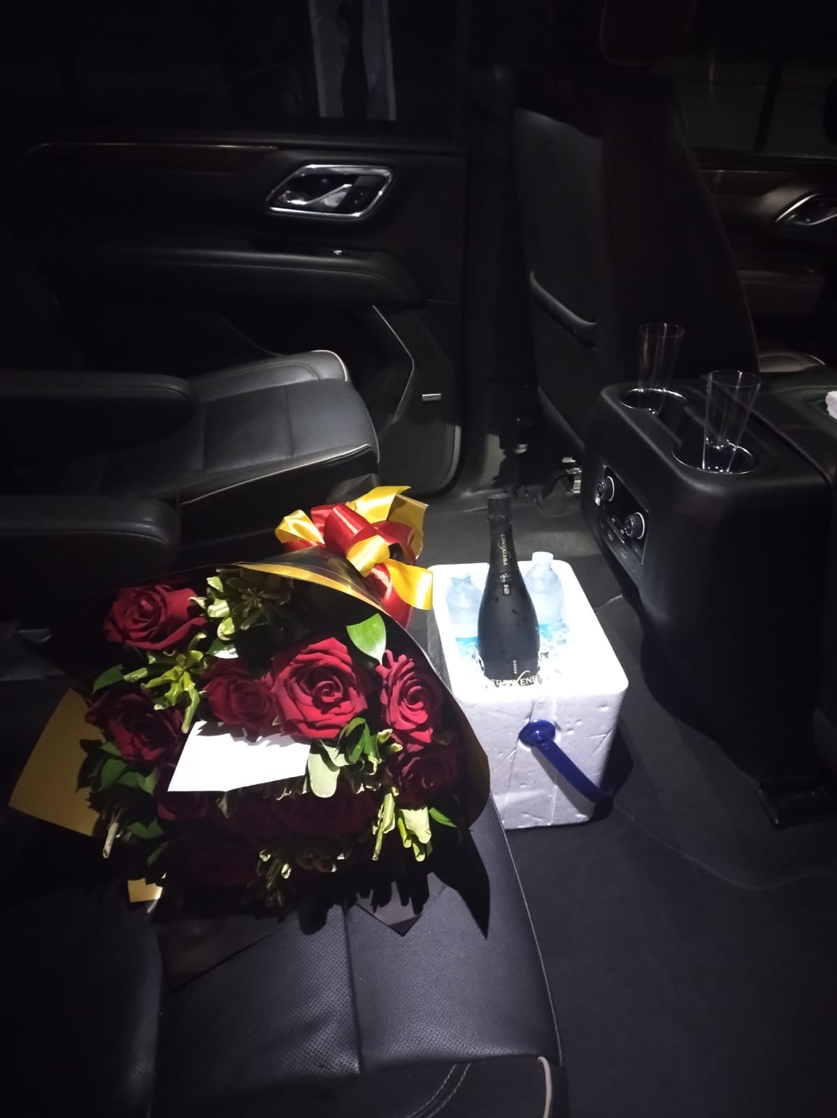 Champagne and flowers prepared inside a premium vehicle